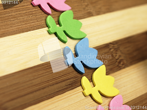 Image of Colorful cut tulips on a chopping board.