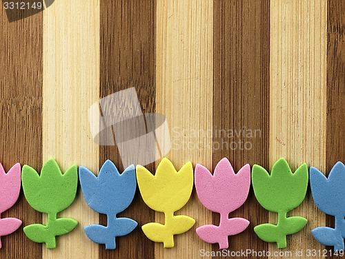 Image of Colorful cut tulips on a chopping board.