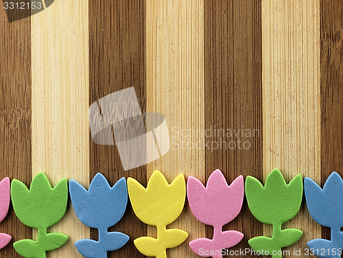 Image of Colorful cut tulips on a chopping board.