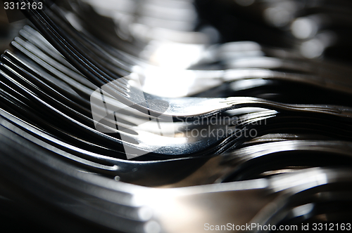 Image of Forks arranged in series on the kitchen table.