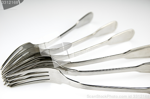 Image of Forks arranged in series on the kitchen table.