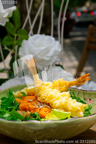 Image of fresh Japanese tempura shrimps with salad