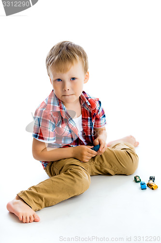 Image of Funny blue-eyed three-year boy. Studio photo