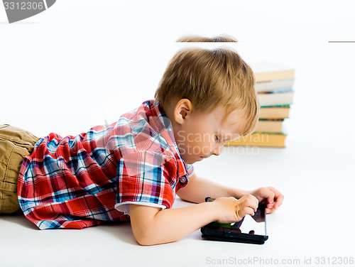 Image of boy lying on the floor with tablet computer