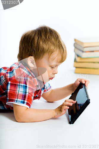 Image of boy lying on the floor with tablet computer