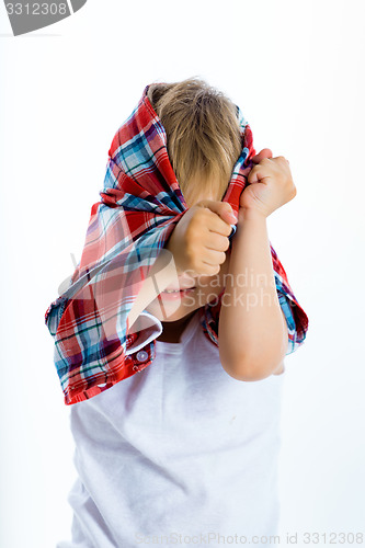Image of Funny blue-eyed three-year boy. Studio photo