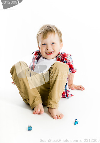 Image of Funny blue-eyed three-year boy. Studio photo