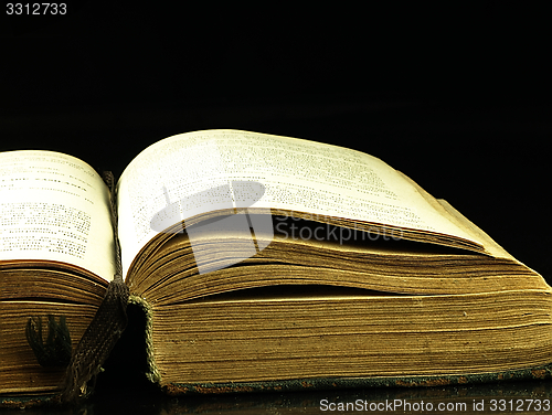 Image of Old, open book with a damaged cover.