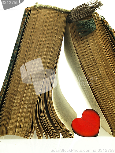 Image of Heart and old closed the book with a damaged cover.