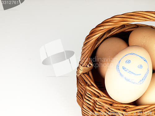 Image of Easter egg with a happy face in the basket.