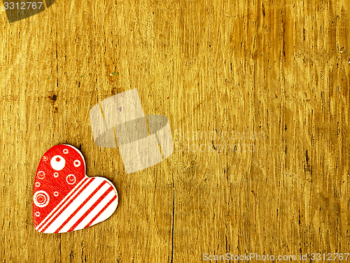 Image of Wooden heart on the oak table.