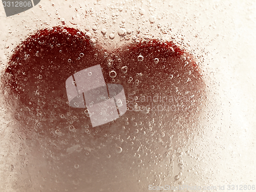 Image of Red heart embedded in ice.