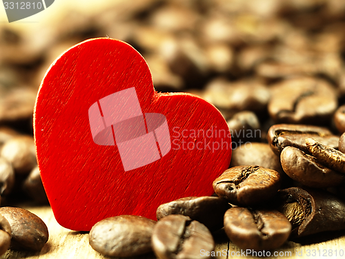 Image of Heart and Coffee beans close-up on wooden, oak table.