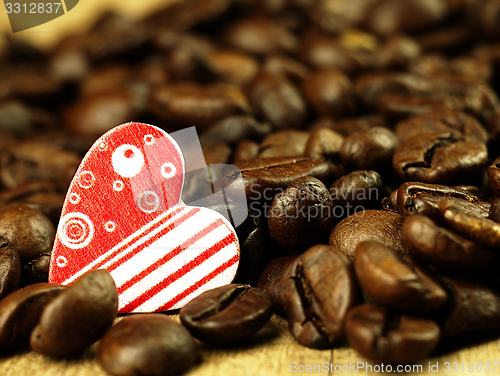 Image of Heart and Coffee beans close-up on wooden, oak table.