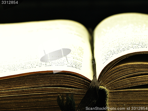 Image of Old, open book with a damaged cover.