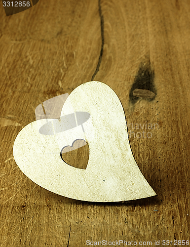 Image of Heart on a wooden boards background.