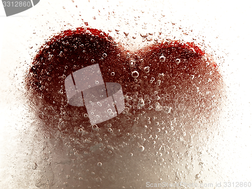 Image of Red heart embedded in ice.