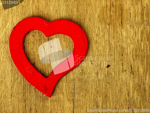 Image of Wooden heart on the oak table.