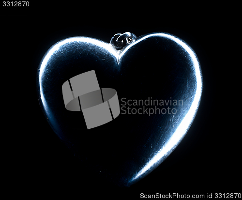 Image of Heart shape emerging from a black background.