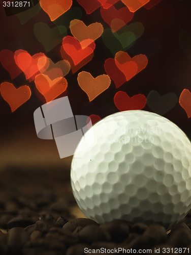 Image of Golf Ball and coffee beans on the table.