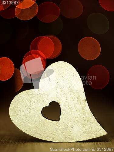 Image of Heart on a wooden boards background.