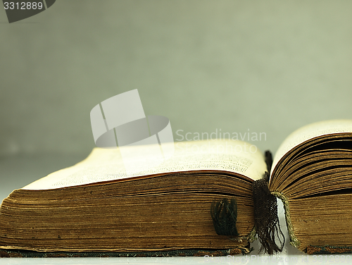 Image of Old, open book with a damaged cover.