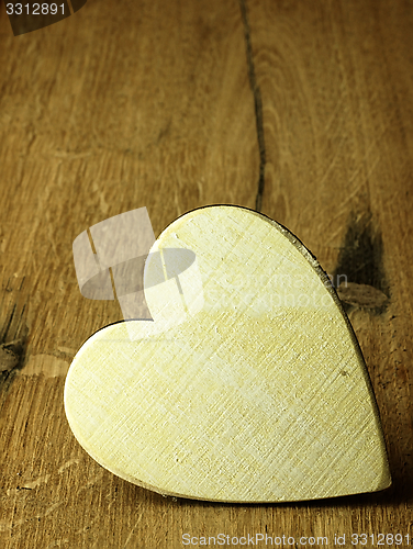 Image of Heart on a wooden boards background.