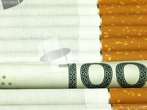 Image of Cigarettes and money. Expensive habit.