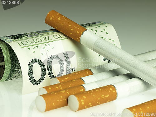 Image of Cigarettes and money. Expensive habit.