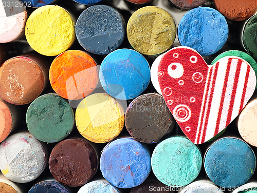 Image of Heart and colored dry pastels closely.