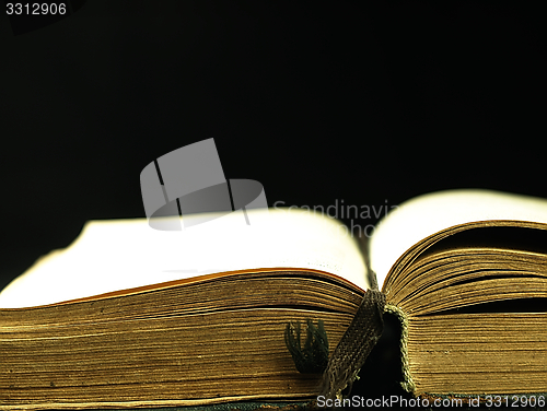 Image of Old, open book with a damaged cover.