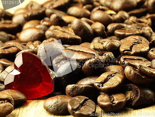 Image of Heart and Coffee beans close-up on wooden, oak table.