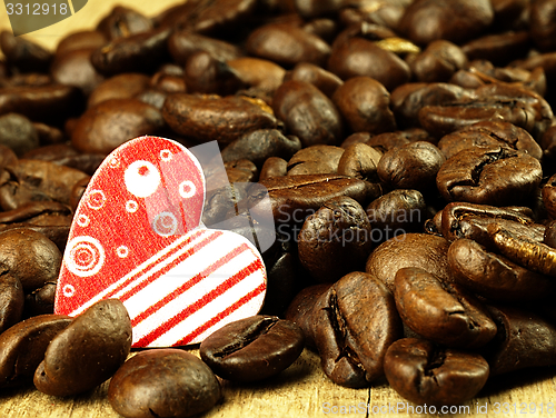 Image of Heart and Coffee beans close-up on wooden, oak table.