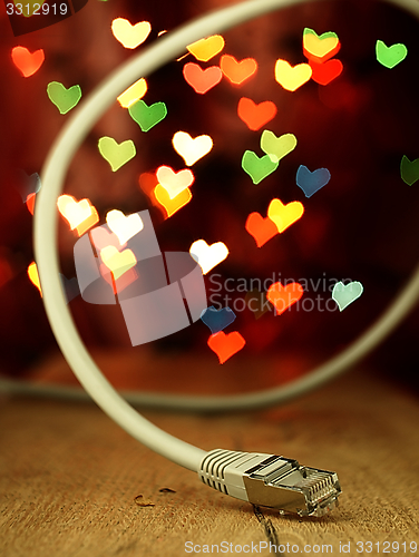 Image of LAN cable on a background of hearts.