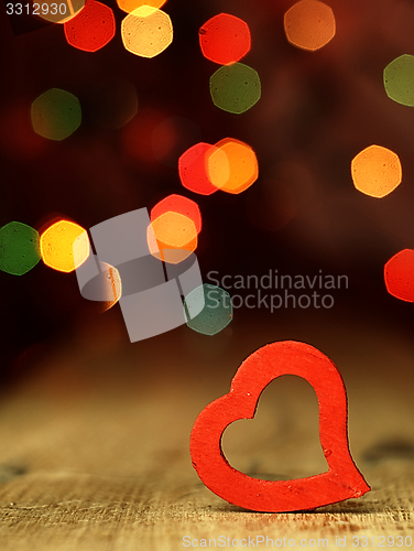 Image of Heart on a wooden boards background.