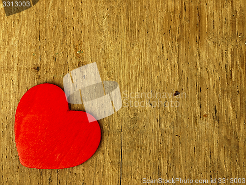 Image of Wooden heart on the oak table.