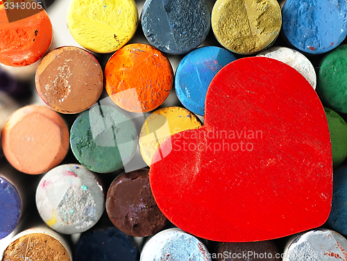 Image of Heart and colored dry pastels closely.