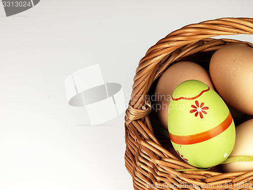 Image of Colorful Easter egg in the company of ordinary eggs.