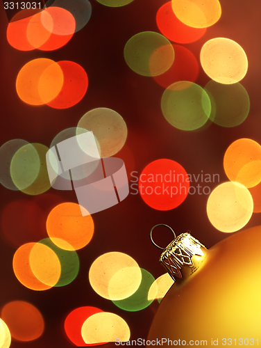 Image of Golden Christmas Tree bauble and magic bokeh.