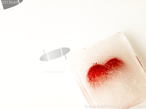 Image of Red heart embedded in ice.