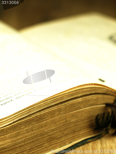 Image of Old, open book with a damaged cover.