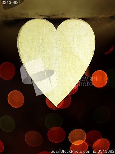 Image of Heart on a wooden boards background.