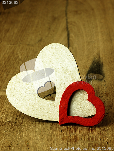 Image of Heart\'s on a wooden boards background.
