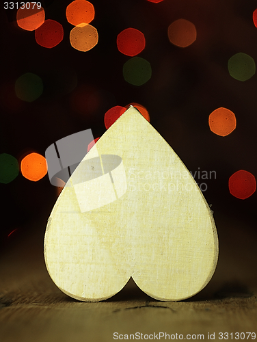 Image of Heart on a wooden boards background.