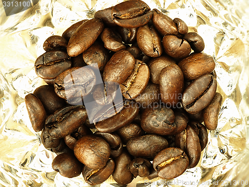 Image of Coffee beans close-up on wooden, oak table.