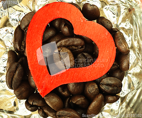 Image of Heart and Coffee beans close-up on wooden, oak table.