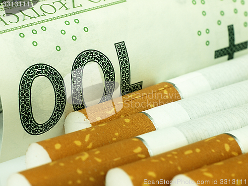 Image of Cigarettes and money. Expensive habit.