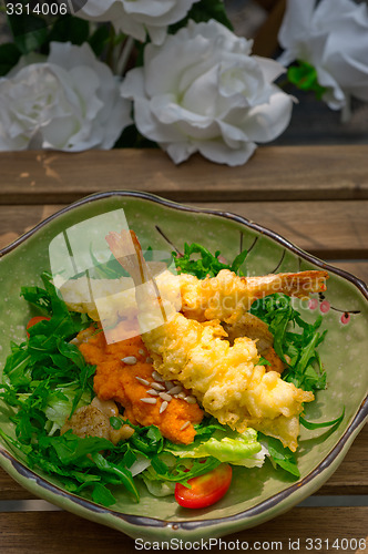 Image of fresh Japanese tempura shrimps with salad