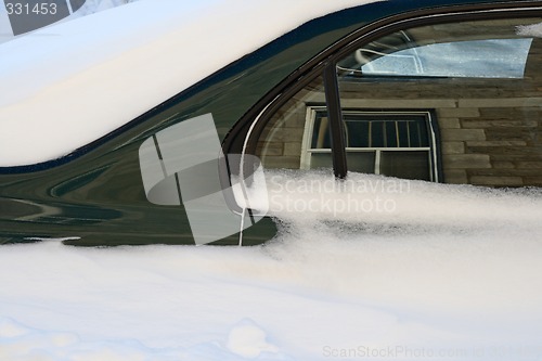 Image of Car in the deep snow reflecting buildings around