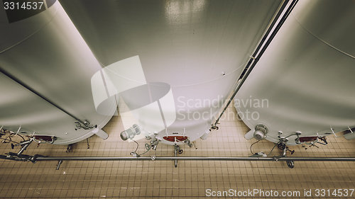 Image of Large industrial white silos in modern factory